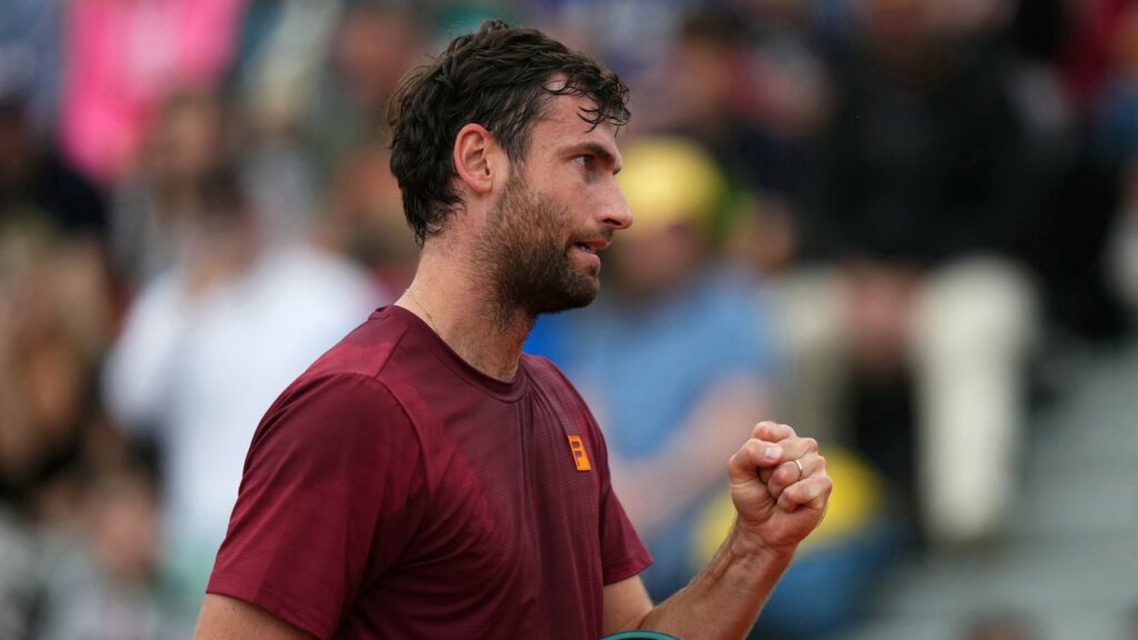 Quentin Halys delivers a powerful ace against Holger Rune at the French Open match in Roland-Garros.