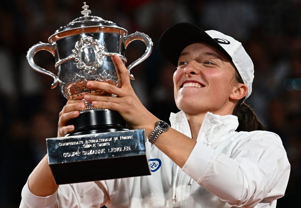 Iga Swiatek celebrates her victory at Roland Garros, extending her winning streak to 24 matches with a focused expression.