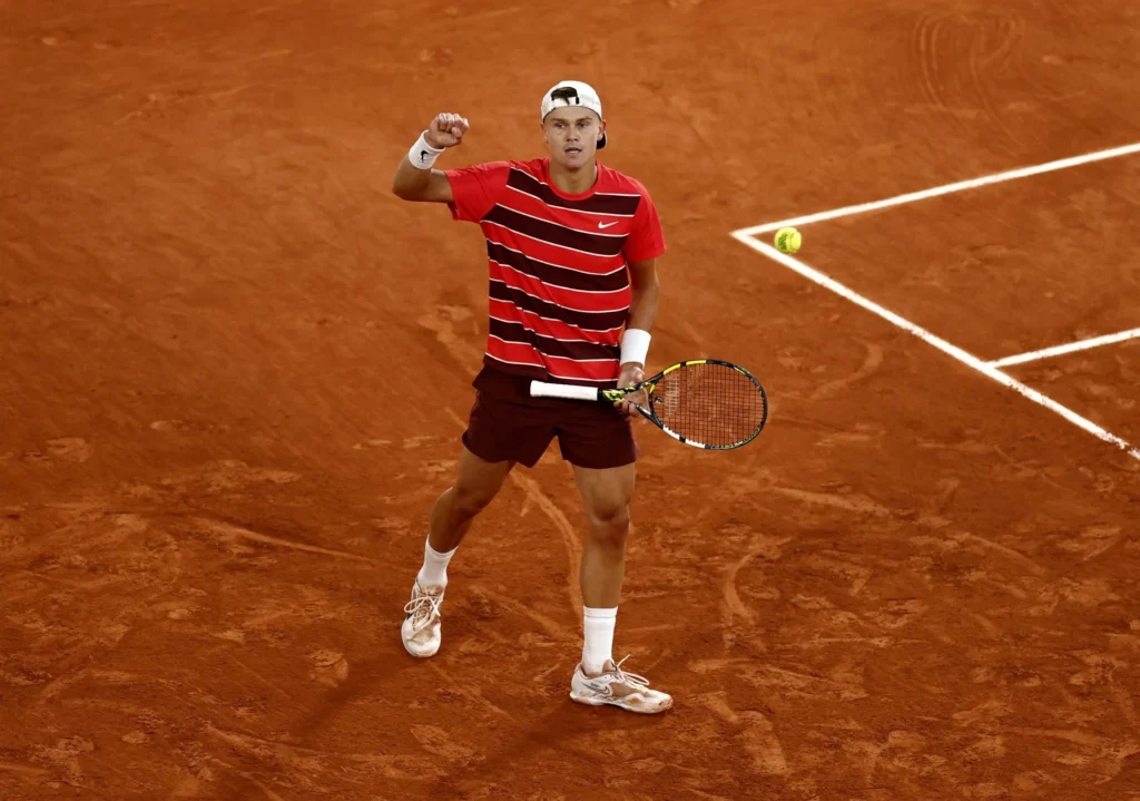 Holger Rune celebrates a victory at the 2025 French Open, showcasing his talent amid the 'towel-gate' incident.