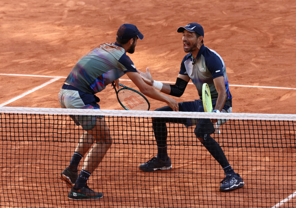 Henry Patten and Harri Heliovaara celebrate advancing in the French Open men's doubles after a strong victory.