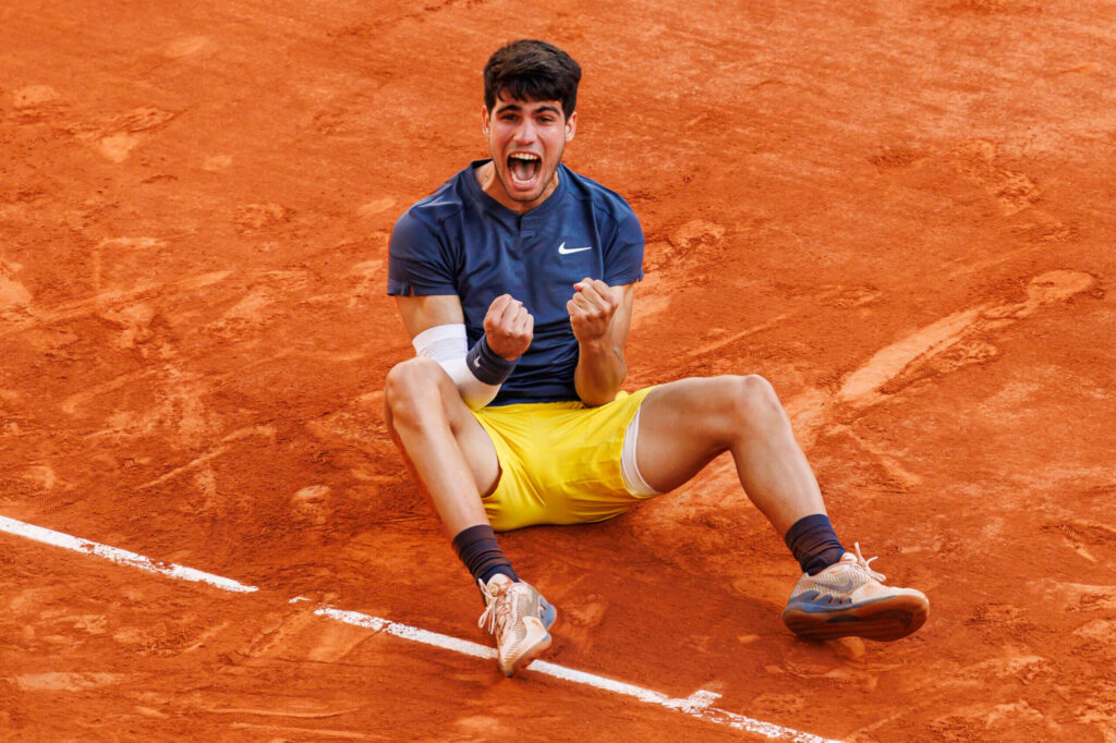 Carlos Alcaraz celebrates his victory over Damir Dzumhur at the French Open, advancing to the fourth round.