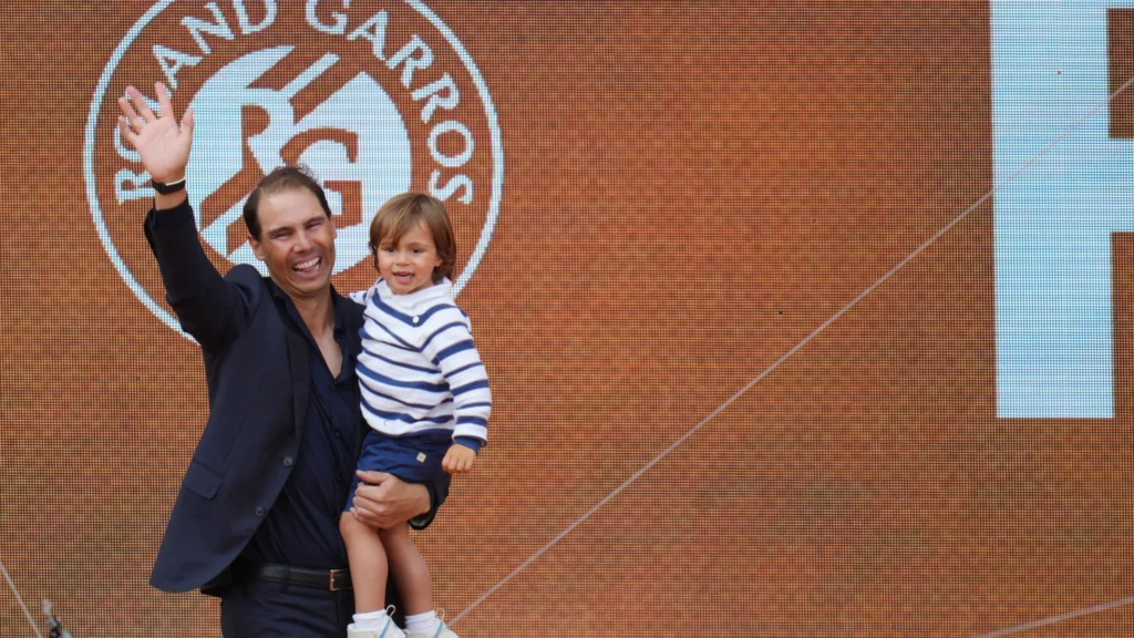 Rafael Nadal embraces Roger Federer, Novak Djokovic, and Andy Murray during his emotional French Open farewell ceremony.