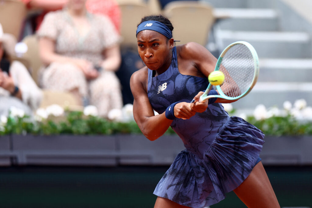 Coco Gauff confidently serves against Marie Bouzkova at the French Open 2025, showcasing her early dominance on the court.