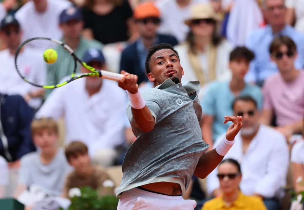 Arthur Fils celebrates his thrilling five-set victory at Roland Garros despite battling through an injury.