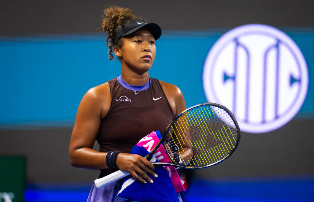 Naomi Osaka smiles while discussing her retirement from the Auckland Classic final due to injury.