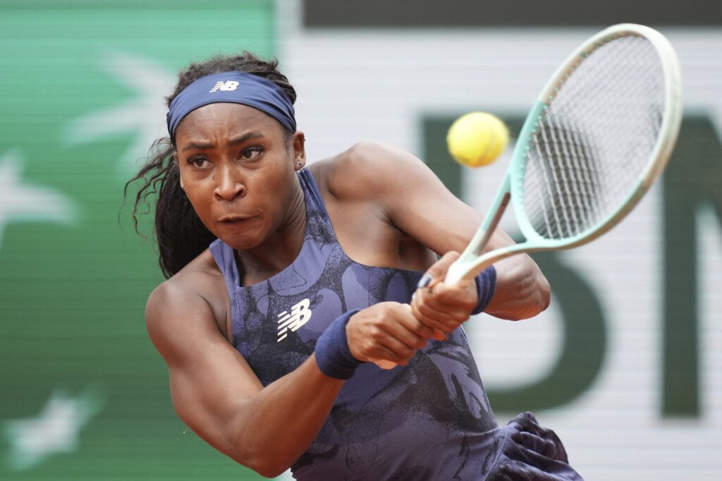 Coco Gauff celebrating her victory at the 2025 French Open, supported by Venus Williams in the background.