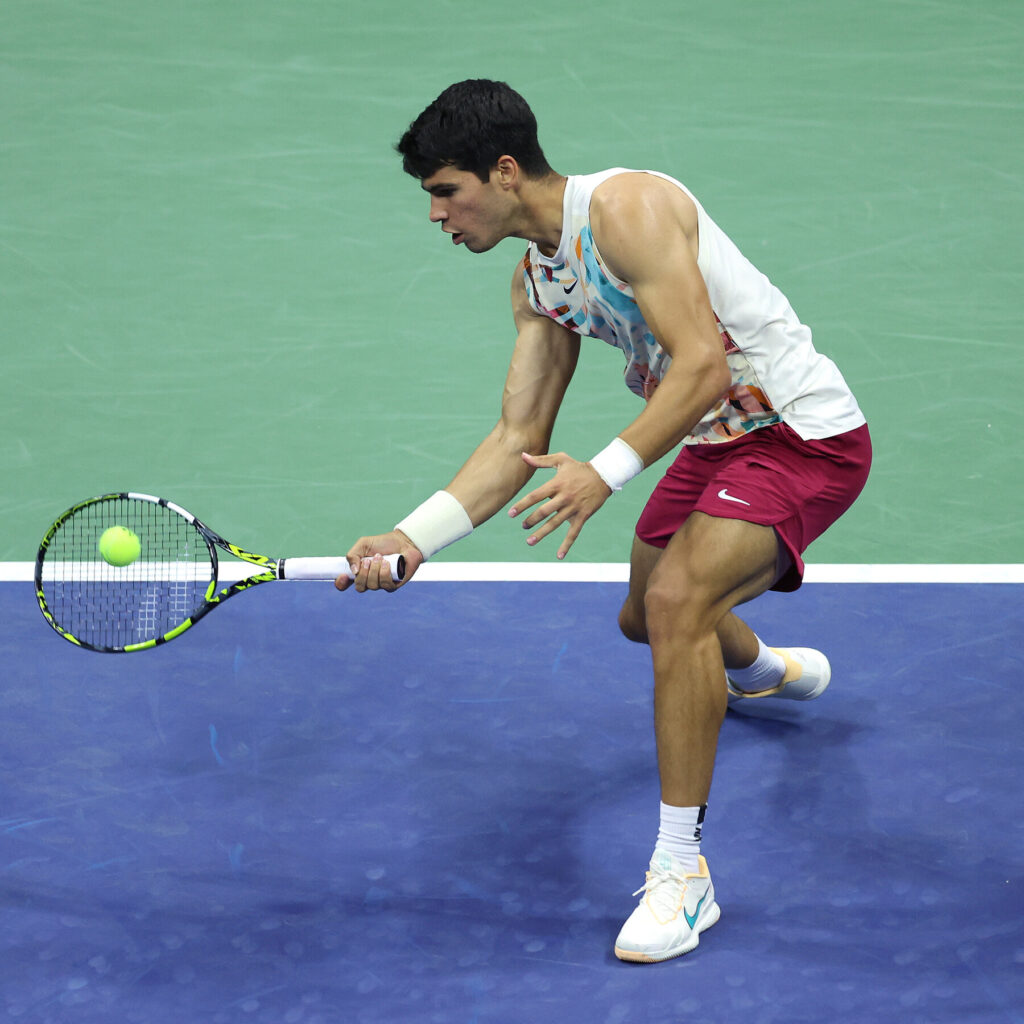 Carlos Alcaraz executes a stunning shot against Ben Shelton during their thrilling French Open match.