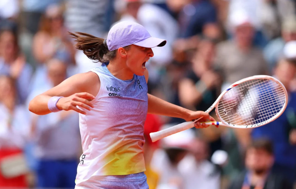 Iga Swiatek celebrating her 2025 French Open comeback victory over Elena Rybakina in a dramatic match.