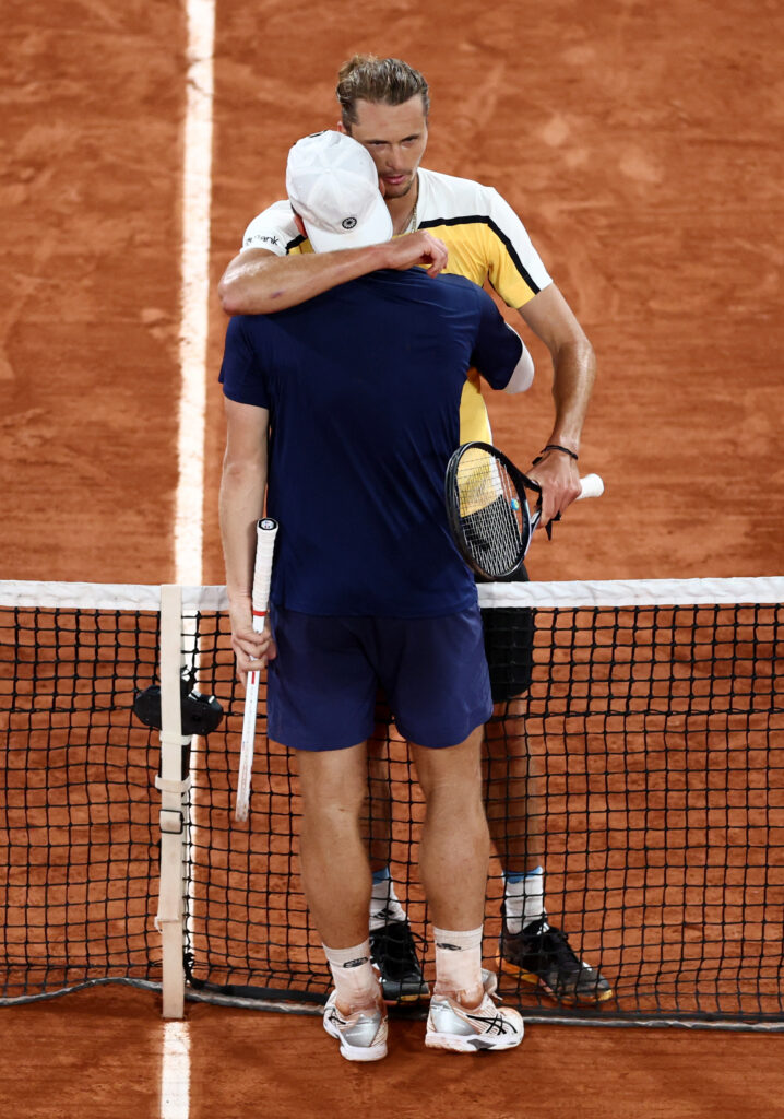 Tallon Griekspoor and Alexander Zverev engage in a thrilling rally at the French Open, showcasing intense tennis skill.