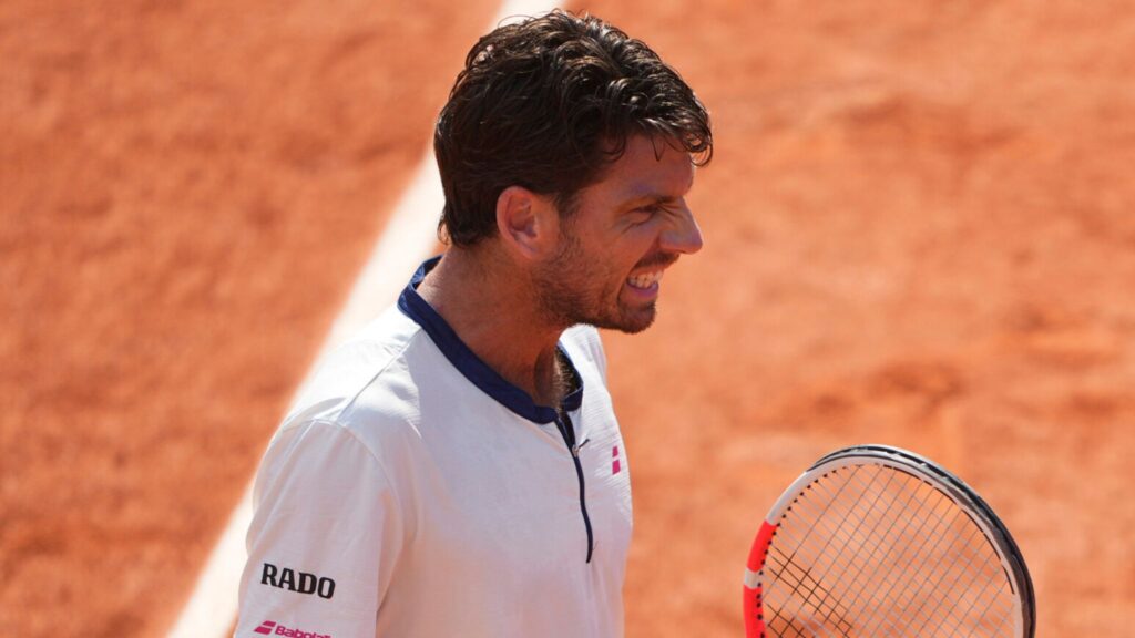 Cameron Norrie celebrates breaking Novak Djokovic's serve early in their thrilling French Open match at Roland-Garros.
