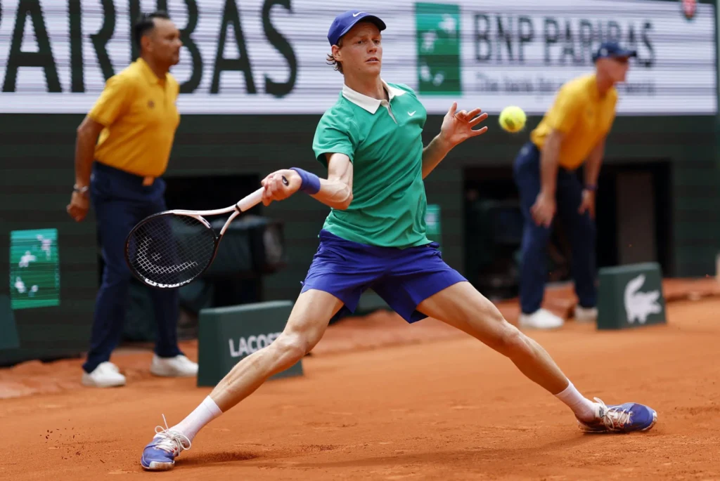 Jannik Sinner in action at the French Open, extending his lead against Andrey Rublev during their match.