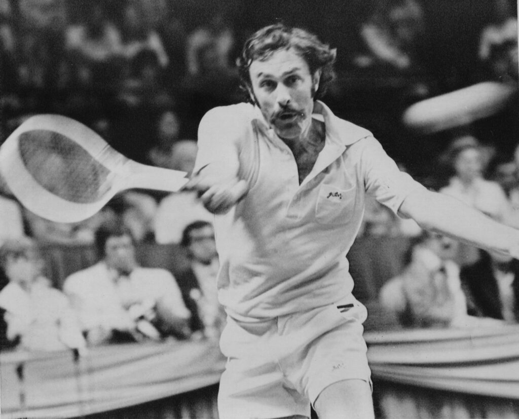John Newcombe celebrates reaching World No. 1 in tennis, showcasing his determination and success in 1974.
