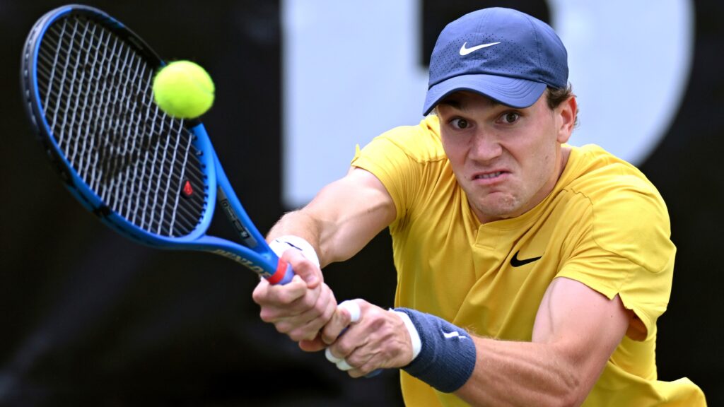 Jack Draper practicing on grass courts, showcasing his skills and preparing for Wimbledon prospects.