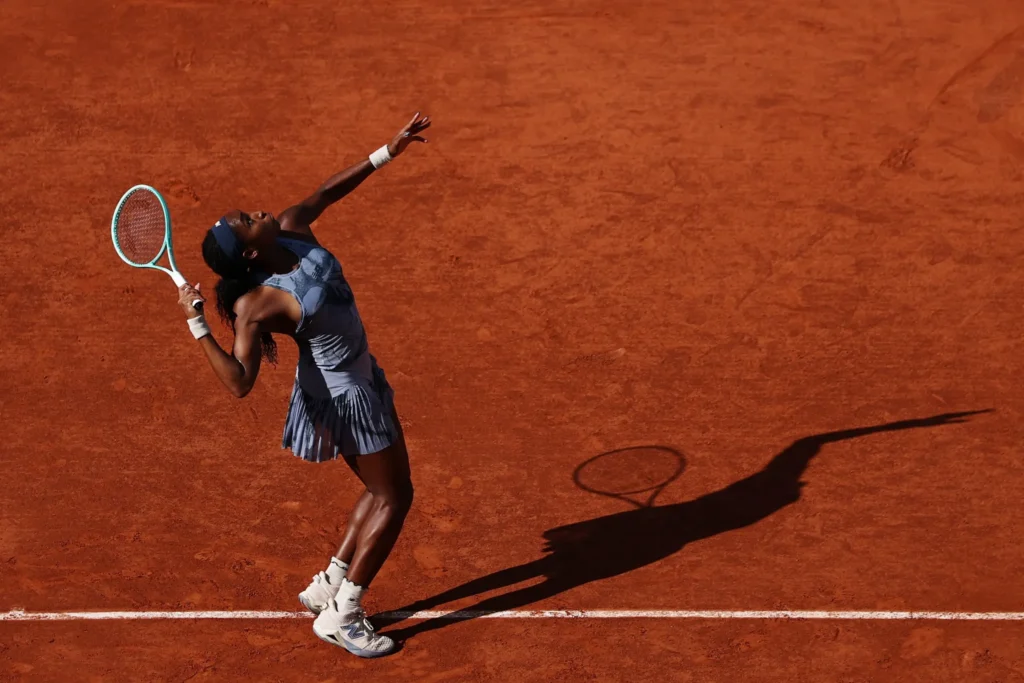 Coco Gauff laughs with Frances Tiafoe, reflecting on her racquet mishap at Roland Garros, showcasing their lighthearted friendship.