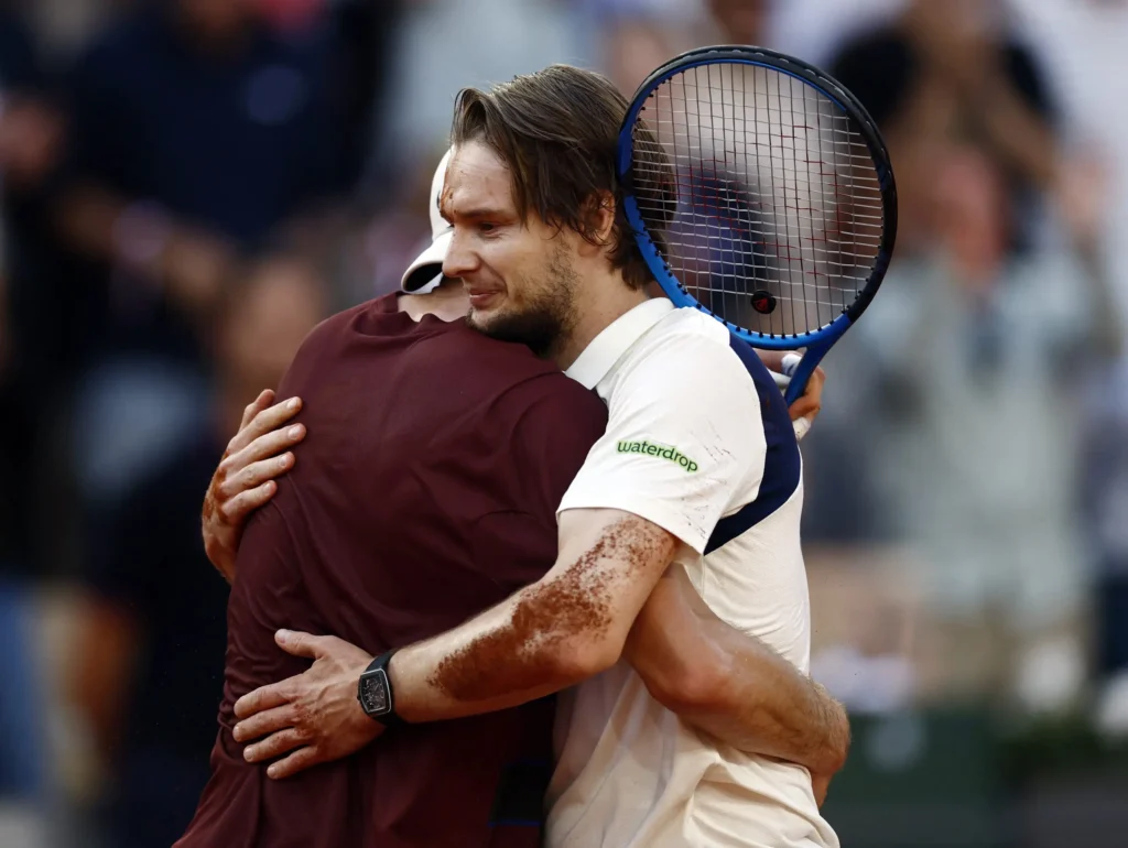 Alexander Bublik celebrating his French Open victory over Jack Draper, expressing joy and emotion on court.