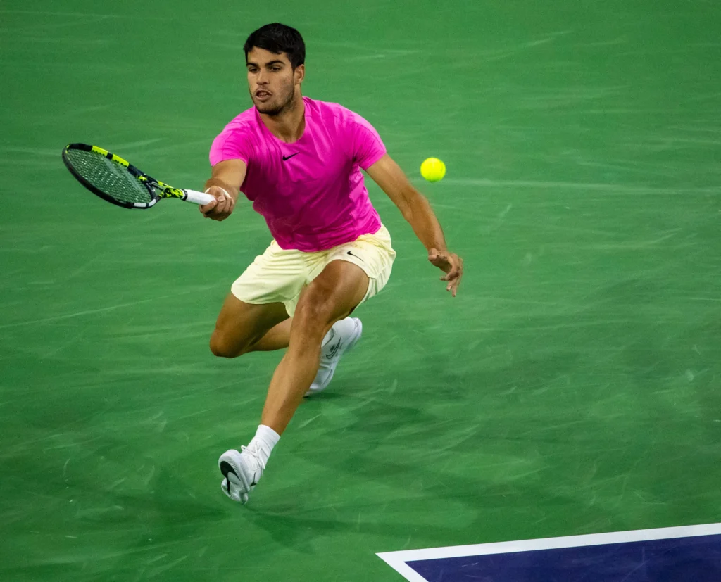 Carlos Alcaraz executes a stunning drop shot against Tommy Paul during the French Open 2025 quarter-finals.