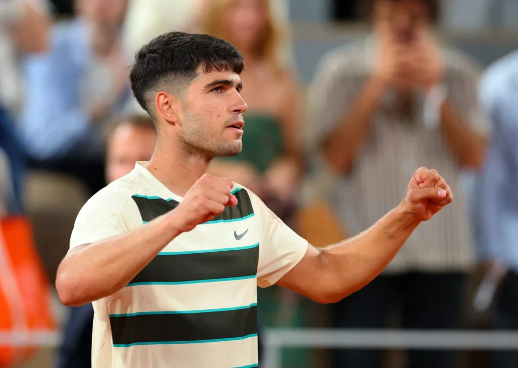 Carlos Alcaraz executing a drop shot during his French Open 2025 quarter-final match against Tommy Paul.