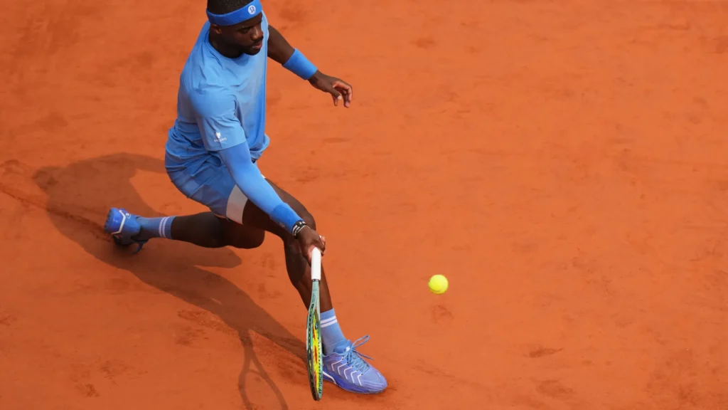 Lorenzo Musetti showcasing his elegant backhand against Frances Tiafoe at the French Open 2025.