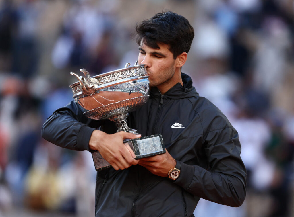 Carlos Alcaraz celebrates his dominant victory at Roland Garros, advancing to the semi-finals with a confident performance.