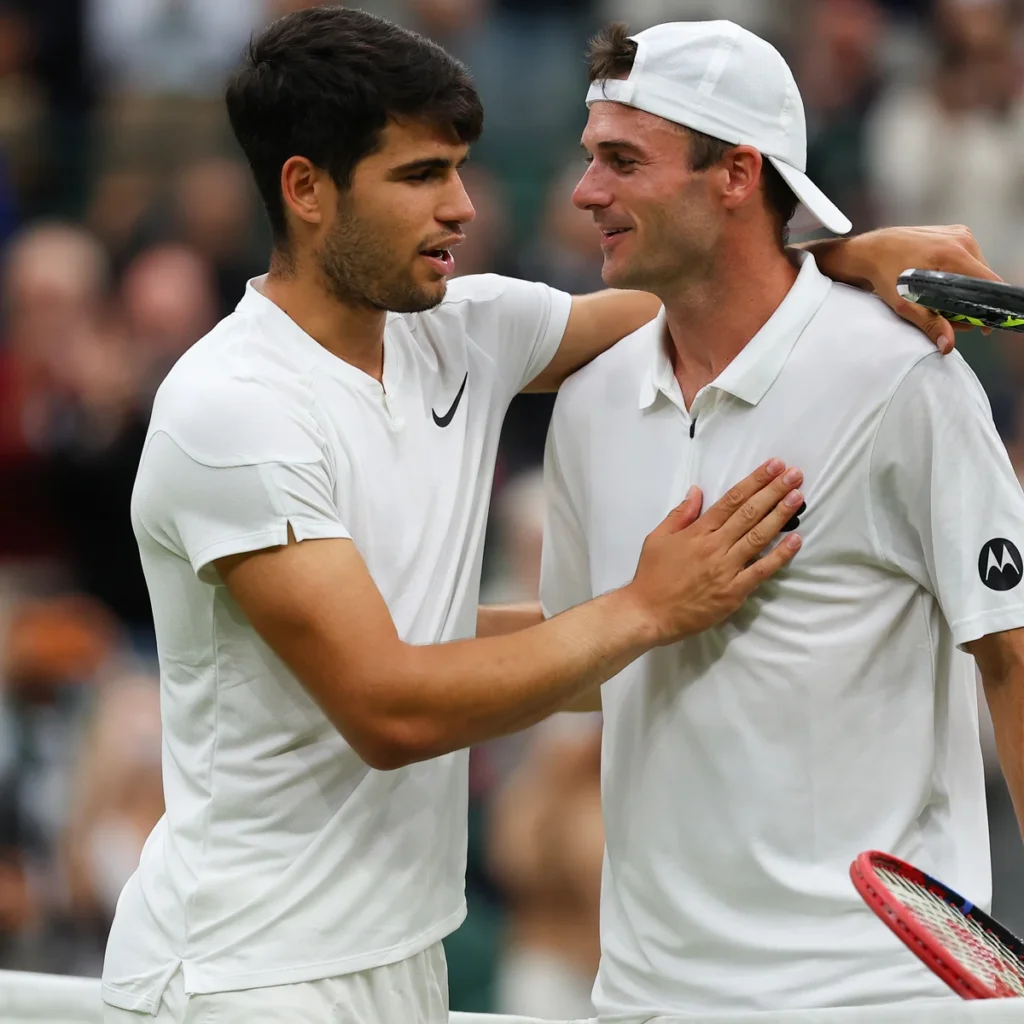Tommy Paul and Carlos Alcaraz compete in an intense match at Roland Garros, showcasing their tennis skills.