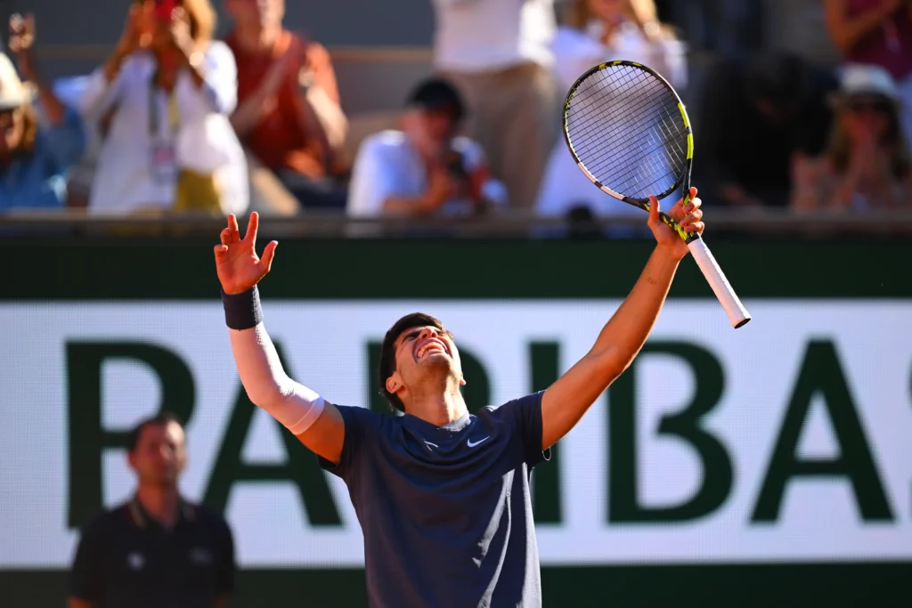 Carlos Alcaraz celebrates his victory, advancing to the French Open semi-finals after defeating Tommy Paul.