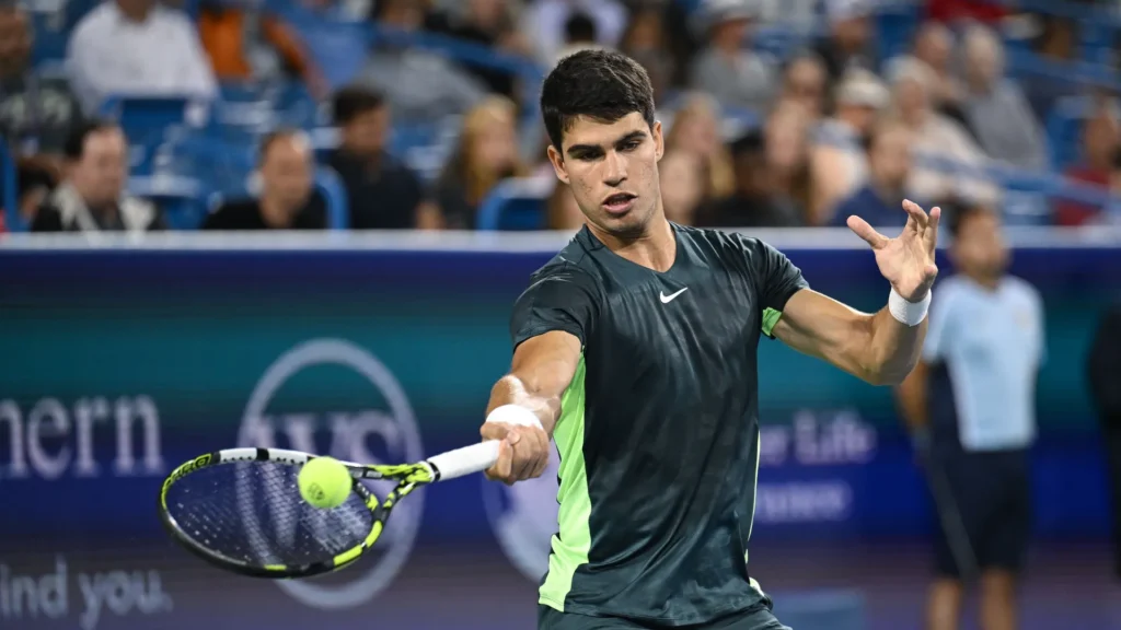 Carlos Alcaraz celebrates his dominant victory over Tommy Paul at Roland-Garros, showcasing his powerful tennis skills.