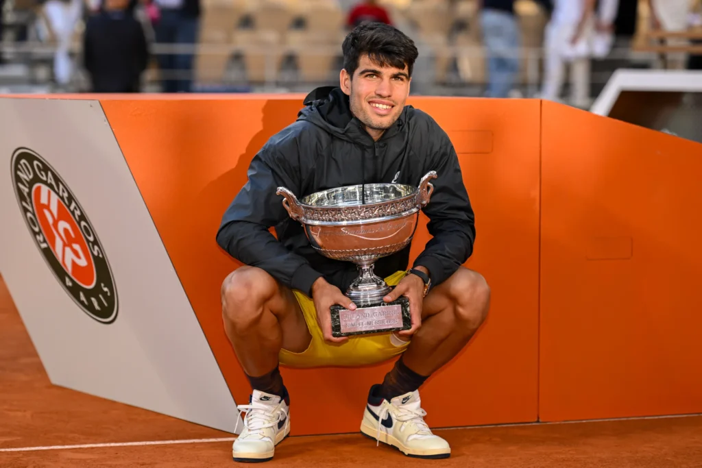 Carlos Alcaraz celebrates his swift victory at the French Open, humorously apologizing to fans after defeating Tommy Paul.