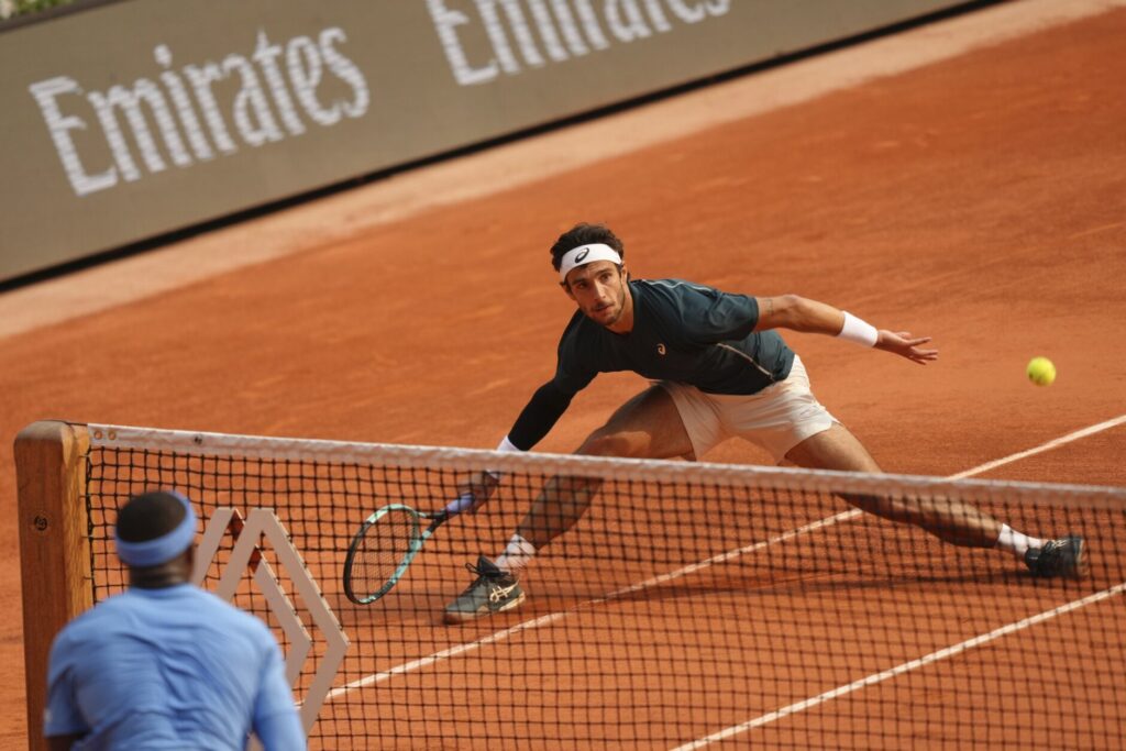 Lorenzo Musetti celebrates after defeating Frances Tiafoe in a controversial French Open quarter-final match.