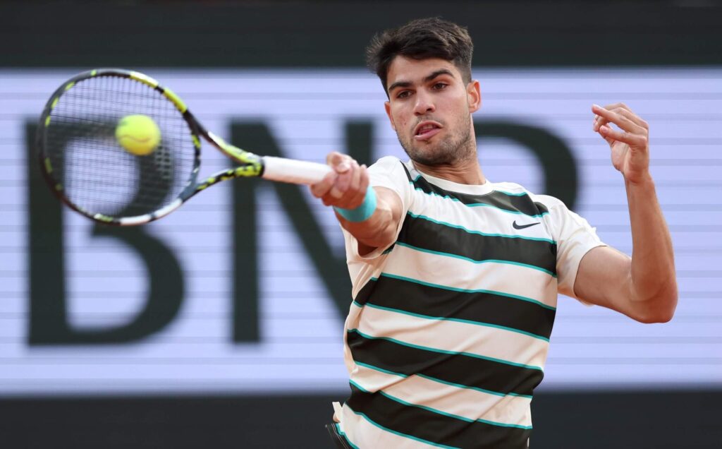 Carlos Alcaraz celebrates his victory over Tommy Paul at the French Open 2025 quarter-finals, showcasing his dominance.