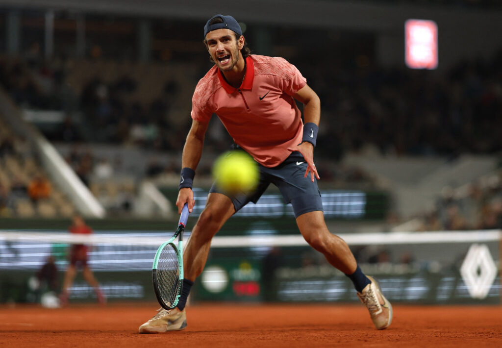 Lorenzo Musetti looks concerned during the French Open after accidentally kicking a ball at a line judge.