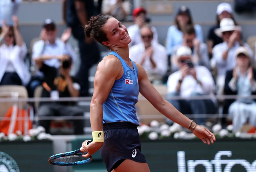 Lois Boisson celebrates her semi-final win at the French Open 2025, capturing the crowd's admiration and joy.