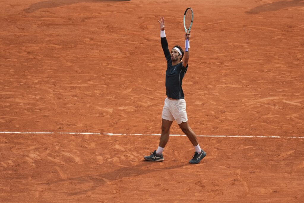 Carlos Alcaraz and Lorenzo Musetti prepare to compete in the Roland Garros semi-finals, showcasing their rivalry.