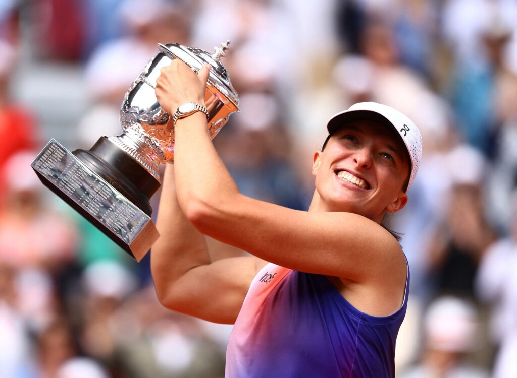 Iga Swiatek celebrates after breaking Aryna Sabalenka's defenses in their French Open semi-final match.