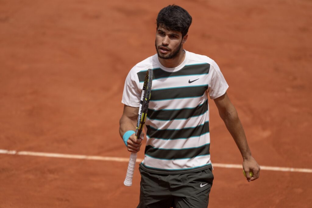 Carlos Alcaraz practicing on clay, showcasing his skills ahead of potential Roland-Garros triumph.