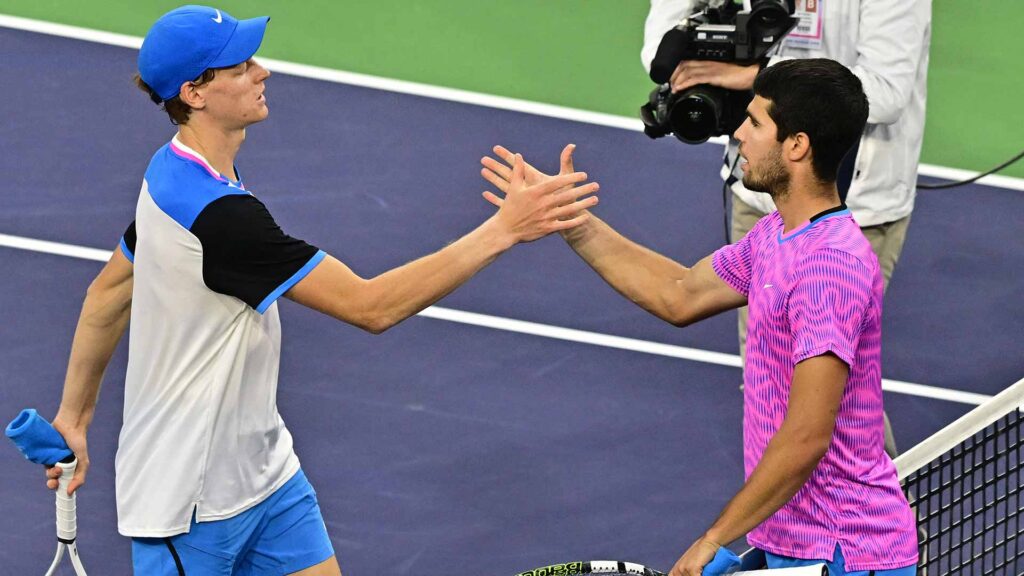 Carlos Alcaraz and Jannik Sinner showcase their distinct playing styles during a tennis match, captivating fans and experts alike.